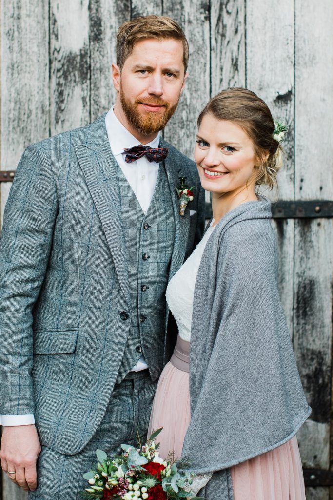 Braut und Bräutigam vor Holzwand